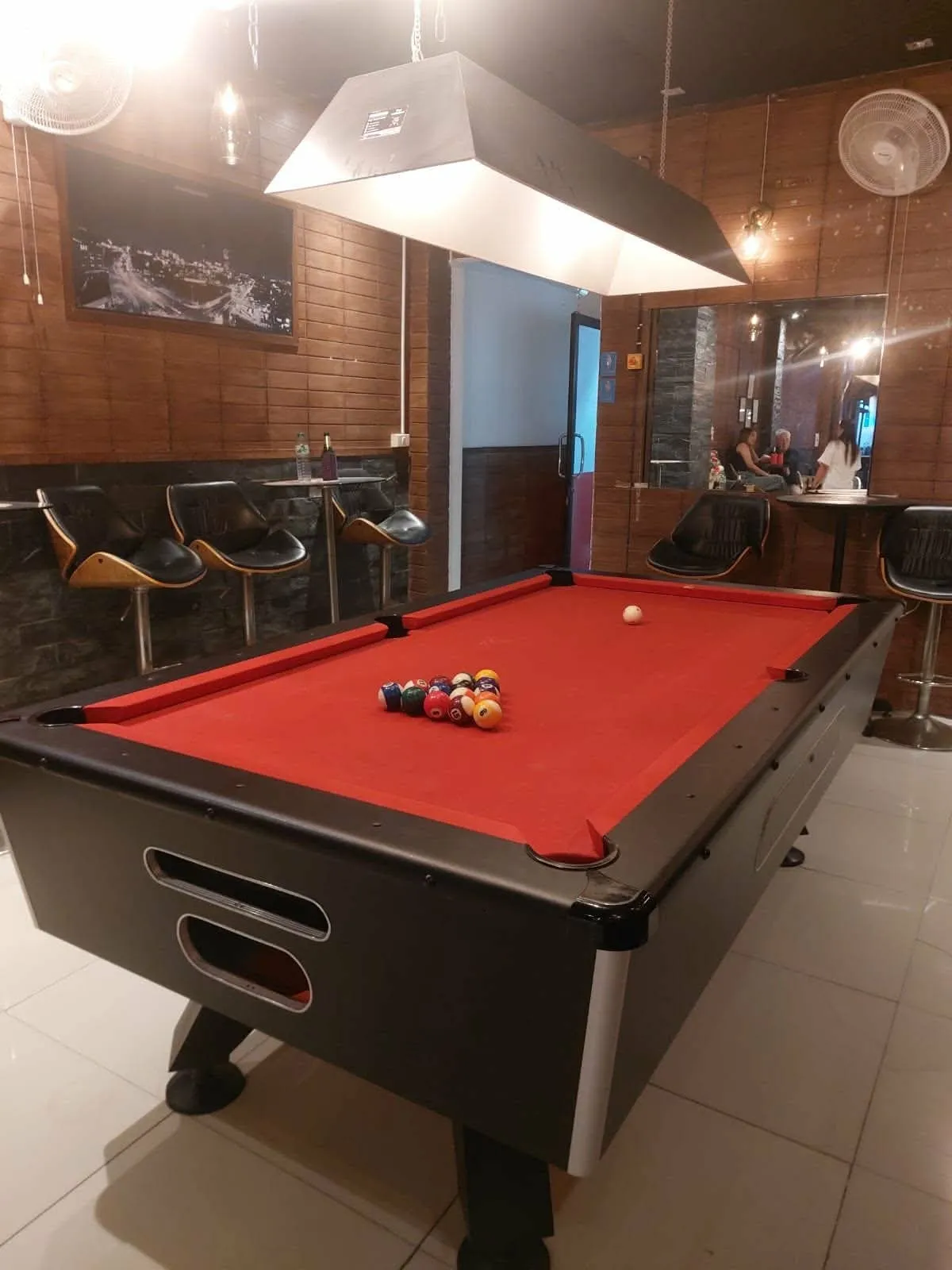 The pool table in the bar, lit from above