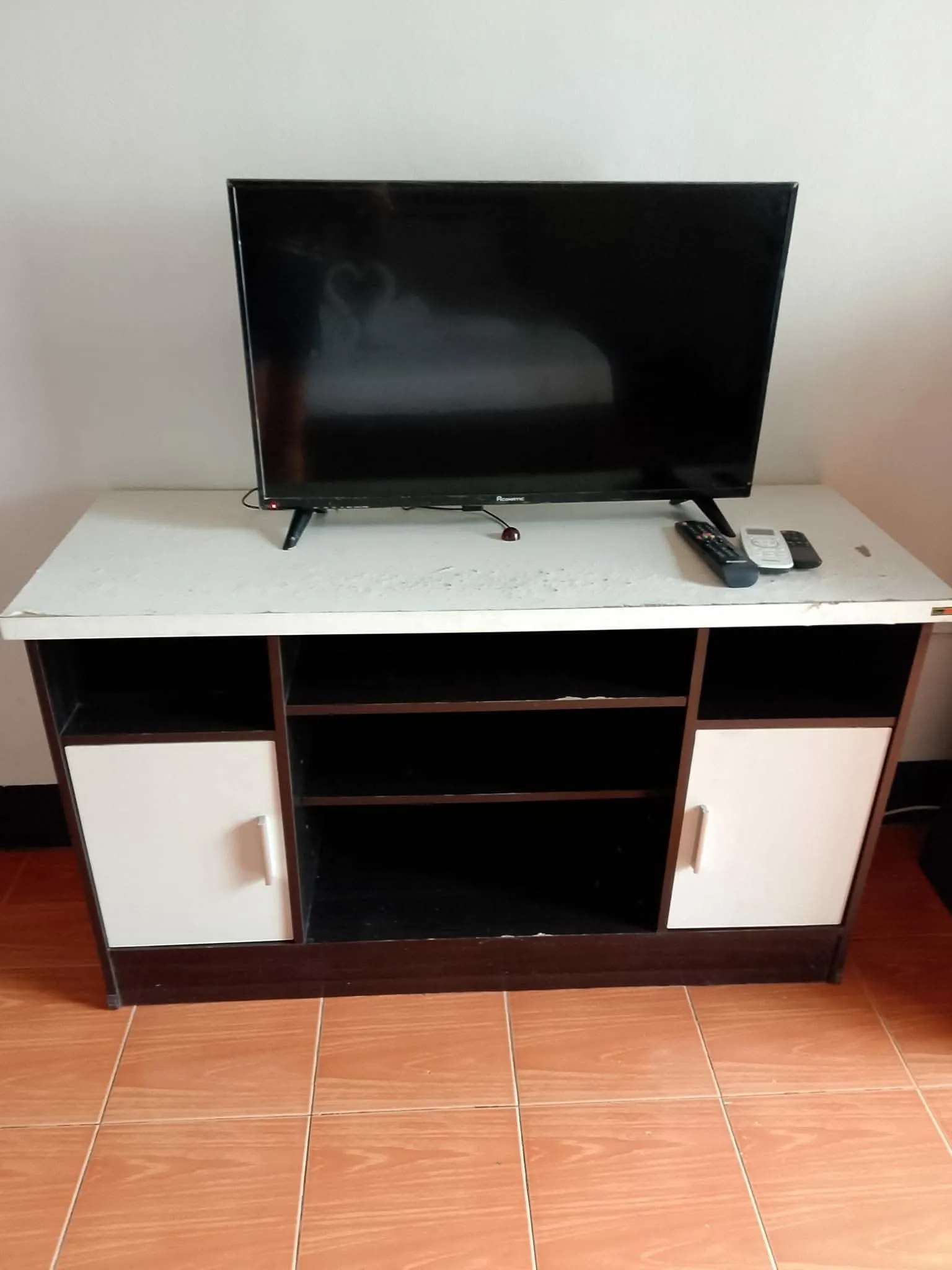 Flat-screen television on a cabinet in the room