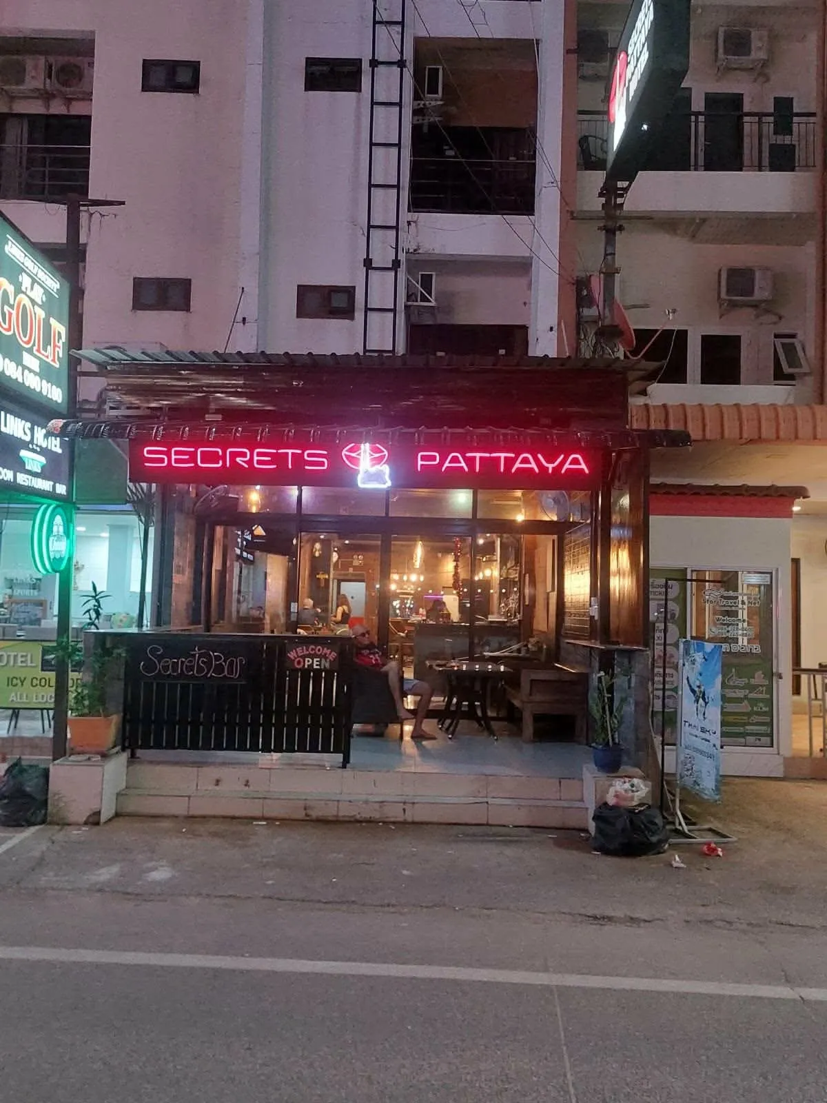 The front of Secrets Pattaya at night, lit by the neon sign above the entrance