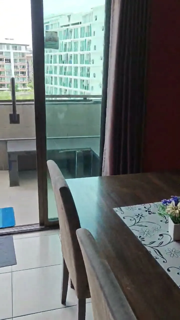 Four-person dining table in the suite, set with a runner and flowers